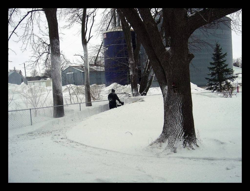 CATHY'S HUSBAND RYAN SNOW BLOWING A MOAT FOR THE CHOWS